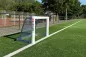 Preview: Profi Minifussballtor aus Ovalprofil, weiß pulverbeschichtet, 120 x 80 cm auf dem Fußballplatz